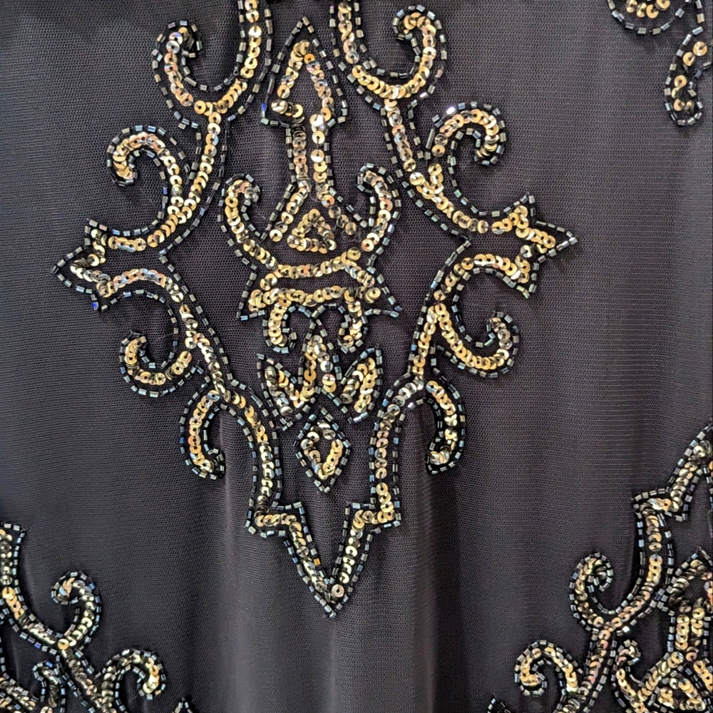 Size 8 Adrianna Papell Gown. In an eggplant/grey with sequins and beading.